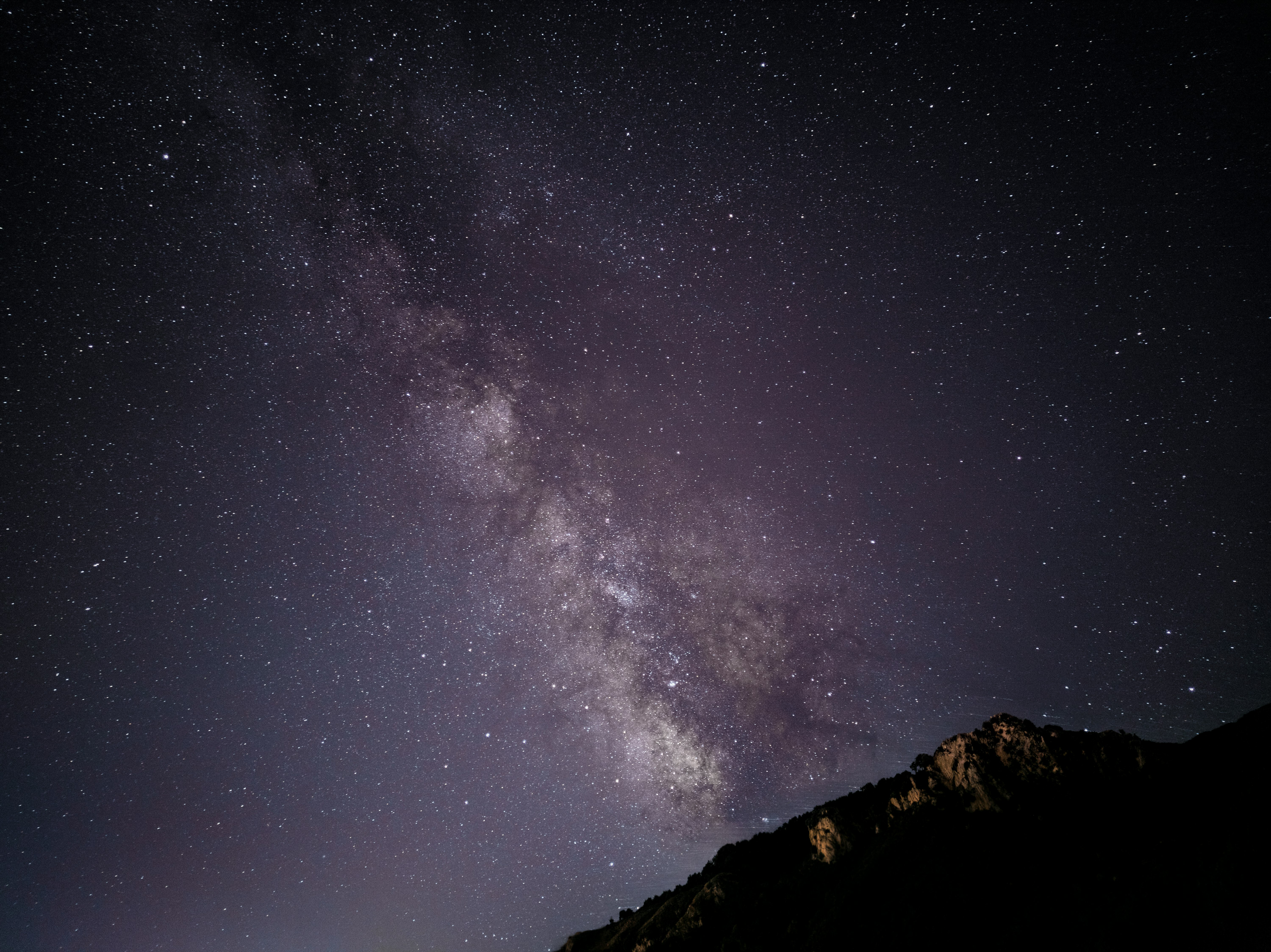 black and white mountain under starry night